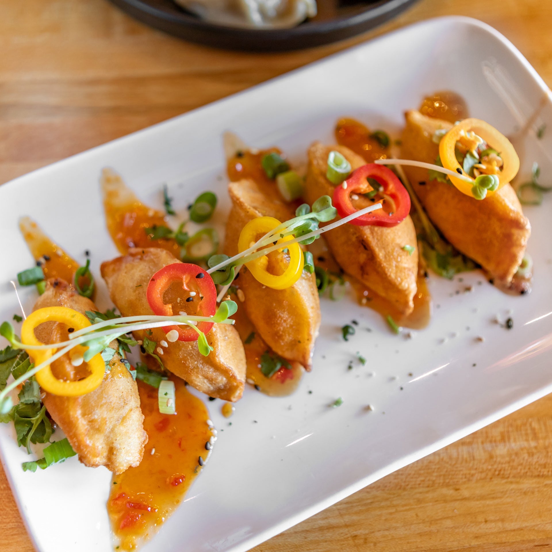 Plated dish of food with garnishes on a wooden table